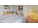 Comfortable bedroom with a queen bed, light green walls, and soft natural light at 10563 Sunblower Ave, Las Vegas, NV 89135