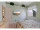 Spacious bedroom with floral bedding, flat screen tv, closet, and large window at 10563 Sunblower Ave, Las Vegas, NV 89135