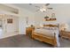 Well-lit bedroom featuring a wooden bed frame, ceiling fan, and ample storage space at 10563 Sunblower Ave, Las Vegas, NV 89135