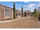 Single-story home featuring a rock yard and covered patio area in the backyard at 10563 Sunblower Ave, Las Vegas, NV 89135