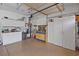 Organized garage space with ample storage cabinets, a workbench, and overhead lighting at 10563 Sunblower Ave, Las Vegas, NV 89135