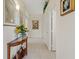 Bright hallway with tile floors, neutral walls, decorative accents, and access to rooms at 10563 Sunblower Ave, Las Vegas, NV 89135