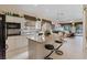 Open-concept kitchen with granite countertops, breakfast bar, and seamless flow to living and dining areas at 10563 Sunblower Ave, Las Vegas, NV 89135
