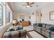 Bright living room with plaid furniture, large windows, and a spacious layout at 10563 Sunblower Ave, Las Vegas, NV 89135