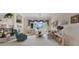 Cozy living room with a fireplace, large window, neutral walls, and carpet flooring at 10563 Sunblower Ave, Las Vegas, NV 89135