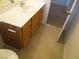 Bathroom featuring a sink and vanity with wooden cabinets and tile flooring at 11039 Pegasus Dr, Las Vegas, NV 89135