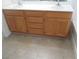 Bathroom vanity with double sinks, wood cabinets, and neutral tile flooring at 11039 Pegasus Dr, Las Vegas, NV 89135