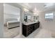 Bathroom featuring double sinks, granite countertops, and wood-look tile floors at 134 Lomita Heights Dr, Las Vegas, NV 89138