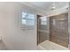 Bathroom featuring glass enclosed shower with pebble-look tile and window at 134 Lomita Heights Dr, Las Vegas, NV 89138