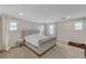 Spacious bedroom with a tufted bed, carpeted floors, and natural light from the windows at 134 Lomita Heights Dr, Las Vegas, NV 89138