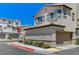 Beautiful new construction home with a two-car garage and colorful landscaping at 134 Lomita Heights Dr, Las Vegas, NV 89138