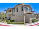 Charming two-story home with stucco exterior, tile roof, and manicured landscaping at 134 Lomita Heights Dr, Las Vegas, NV 89138