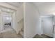 Hallway featuring carpeted floors, stairwell, and access to various rooms, offers a cohesive design at 134 Lomita Heights Dr, Las Vegas, NV 89138