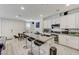 Bright kitchen with granite countertops, island with seating, and white cabinets offers a modern design at 134 Lomita Heights Dr, Las Vegas, NV 89138