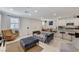 Open concept living room with modern finishes, stylish furniture, and an adjacent kitchen at 134 Lomita Heights Dr, Las Vegas, NV 89138