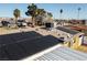 Aerial view of a home with solar panels on the roof and palm trees in the yard at 1805 Helen Ave, North Las Vegas, NV 89032