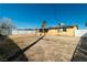 Large backyard with a large dirt area and mature palm trees at 1805 Helen Ave, North Las Vegas, NV 89032