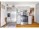 Renovated kitchen with stainless steel appliances and mosaic backsplash at 1805 Helen Ave, North Las Vegas, NV 89032