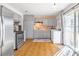 Updated kitchen with stainless steel appliances, gray cabinets, and adjacent laundry at 1805 Helen Ave, North Las Vegas, NV 89032