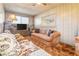 Comfortable living room featuring neutral tones, ceiling fan, and natural light, perfect for relaxation and entertaining at 1805 Helen Ave, North Las Vegas, NV 89032