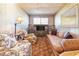 Cozy living room with wood paneled walls, carpeted floors, and comfortable furniture at 1805 Helen Ave, North Las Vegas, NV 89032