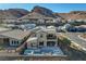 Aerial view of a modern home with a pool, patio, and stunning mountain backdrop at 1968 Regal Bluff Dr, Henderson, NV 89052