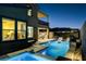 Luxurious backyard with a sparkling pool, spa, covered patio, and outdoor lounge area at 1968 Regal Bluff Dr, Henderson, NV 89052