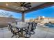 Outdoor kitchen with a grill, dining table, pool and mountain views at 1968 Regal Bluff Dr, Henderson, NV 89052