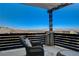 A cozy balcony with scenic mountain views and comfortable wicker furniture at 1968 Regal Bluff Dr, Henderson, NV 89052
