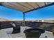 A cozy balcony with scenic mountain views and comfortable wicker furniture at 1968 Regal Bluff Dr, Henderson, NV 89052