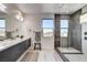 Bathroom with a glass enclosed shower, double vanity, and modern fixtures at 1968 Regal Bluff Dr, Henderson, NV 89052