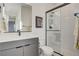 Modern bathroom featuring a glass enclosed shower and a sleek gray vanity with undermount sink at 1968 Regal Bluff Dr, Henderson, NV 89052