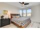 Cozy bedroom with wood-look flooring, dark furniture, and natural light from the windows at 1968 Regal Bluff Dr, Henderson, NV 89052