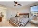 Cozy bedroom with wood-look flooring, dark furniture, and natural light from the windows at 1968 Regal Bluff Dr, Henderson, NV 89052