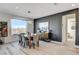 Bright dining room features modern chandelier, gray accent wall, and beautiful view at 1968 Regal Bluff Dr, Henderson, NV 89052