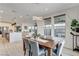 Bright dining room features modern chandelier, wooden table, and view to the backyard at 1968 Regal Bluff Dr, Henderson, NV 89052