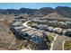 An aerial view of an upscale community showcasing modern homes nestled against a backdrop of mountains at 1968 Regal Bluff Dr, Henderson, NV 89052