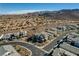 An aerial view shows modern homes within a planned community, featuring beautiful mountain views and desert landscape at 1968 Regal Bluff Dr, Henderson, NV 89052