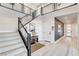 Bright foyer features modern staircase, light wood floors, and stylish decor at 1968 Regal Bluff Dr, Henderson, NV 89052