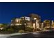 Modern two-story home with professional landscaping, stone details and a contemporary garage door at 1968 Regal Bluff Dr, Henderson, NV 89052