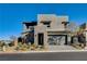 Modern two-story home featuring stone accents, an attached garage, and xeriscaped front yard at 1968 Regal Bluff Dr, Henderson, NV 89052