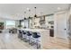 Stylish kitchen featuring island with bar seating, modern appliances, and dining area at 1968 Regal Bluff Dr, Henderson, NV 89052