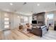 Bright living room boasts hardwood floors, fireplace, a sleek ceiling fan, and abundant natural light at 1968 Regal Bluff Dr, Henderson, NV 89052