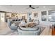 Open-concept living room with kitchen view, natural light, and modern furniture at 1968 Regal Bluff Dr, Henderson, NV 89052