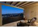 Enjoy breathtaking city views from the comfortable seating area on the covered patio at 1968 Regal Bluff Dr, Henderson, NV 89052