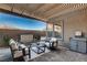 Relaxing covered patio with stylish furniture and a serene atmosphere for outdoor enjoyment at 1968 Regal Bluff Dr, Henderson, NV 89052