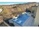 A gorgeous in-ground pool featuring lounge seating, a hot tub, and lovely desert landscaping at 1968 Regal Bluff Dr, Henderson, NV 89052