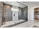 This glass enclosed shower features dual shower heads, decorative tile, and bench at 1968 Regal Bluff Dr, Henderson, NV 89052