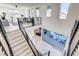 Modern staircase leading to a living room area and outdoor patio with large glass sliding doors at 1968 Regal Bluff Dr, Henderson, NV 89052