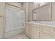 Bathroom featuring a shower-tub, a mirror, a vanity with a white countertop, and neutral paint at 2101 Strada Mia Ct, Las Vegas, NV 89117